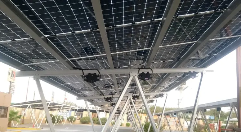 Underneath a solar carport canopy, the units mounted below the panels